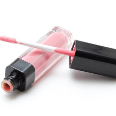 Pink lip gloss on white background